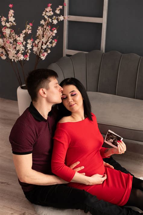 fotografė atsargiai pozuoja kūdikį studijoje