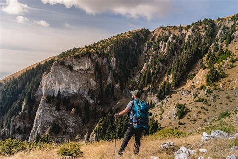 Asmuo keliauja kalnų taku, simbolizuojantį gyvenimo kelią