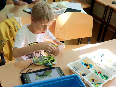 Vaikai, konstruojantys robotus robotikos stovykloje