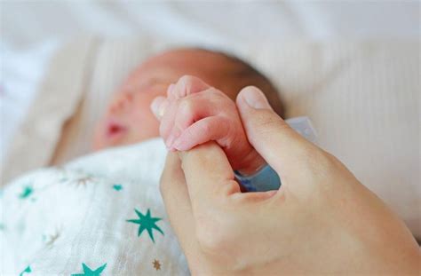 moteris su kūdikiu jaukioje aplinkoje