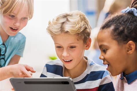 Vaikai naudoja planšetę edukaciniams žaidimams