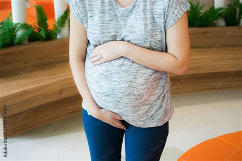 pregnant woman holding her belly in pain