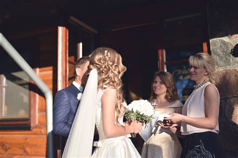 tėvai džiaugsmingai apkabina jaunuosius vestuvių dieną