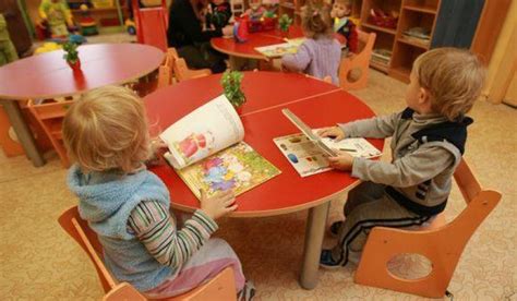 vaikai darželio grupėje prie stalo