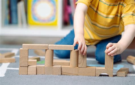 toddler playing with educational wooden blocks