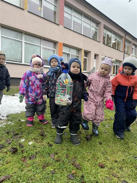 Vaikai stebi jazmino krūmą darželio kieme