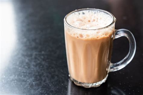 Vaiko ranka, laikanti puodelį su arbata